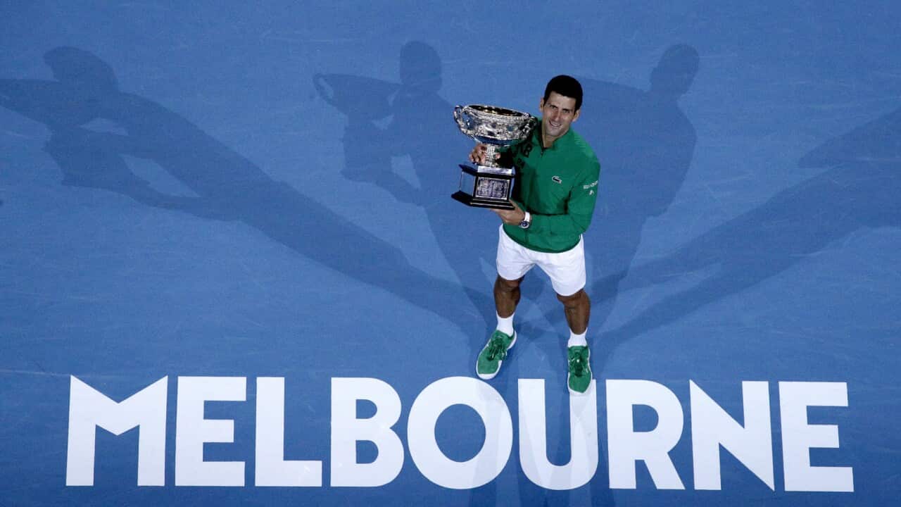Novak Djokovic holds his Australian Open trophy