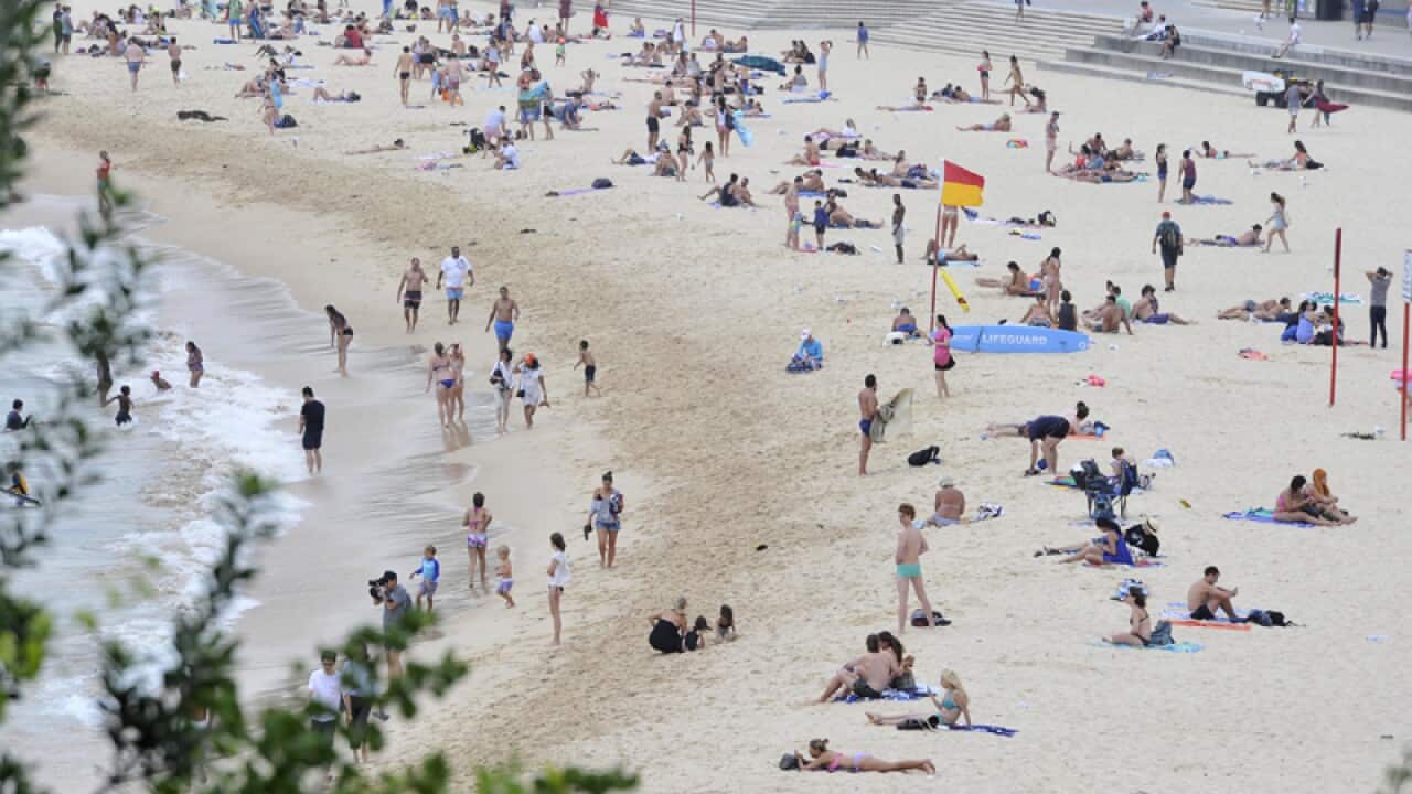 People enjoy the sand at Coogee Beach