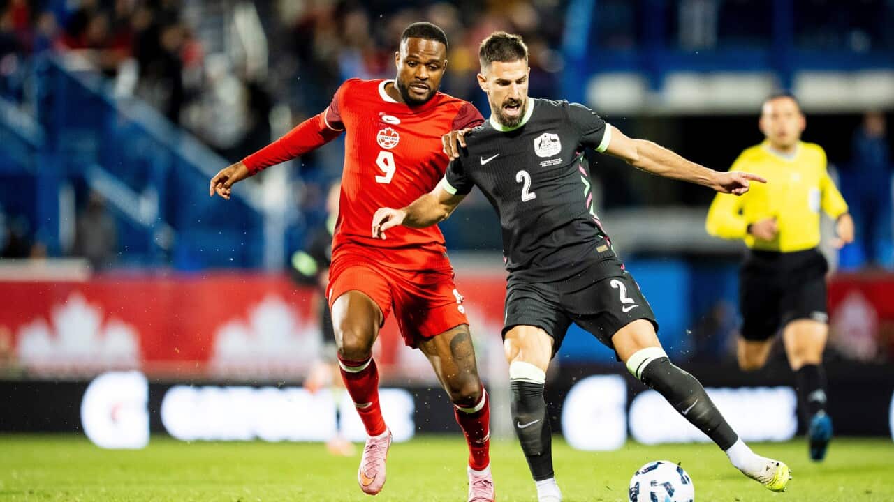 Australia's Milos Degenek (2) defends against Canada's Cyle Larin (9) during international friendly match in Montreal