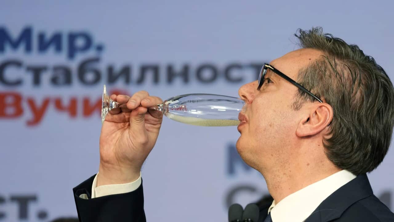 Aleksandar Vucic drinks champagne after claiming victory in the presidential election in Belgrade, Serbia, Sunday, April 3, 2022.