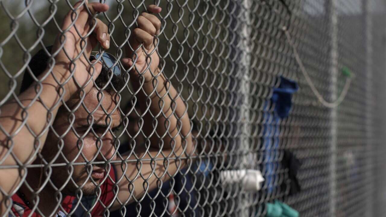 A man waits to be registered after arriving in Greece