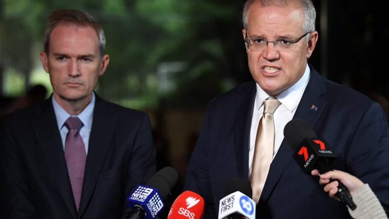 Immigration Minister David Coleman (left) and Prime Minister Scott Morrison hold a doorstop after attending Mass at St Mark Coptic Orthodox Church at Arncliffe in Sydney, Sunday, March 17, 2019. (AAP Image/Joel Carrett) NO ARCHIVING