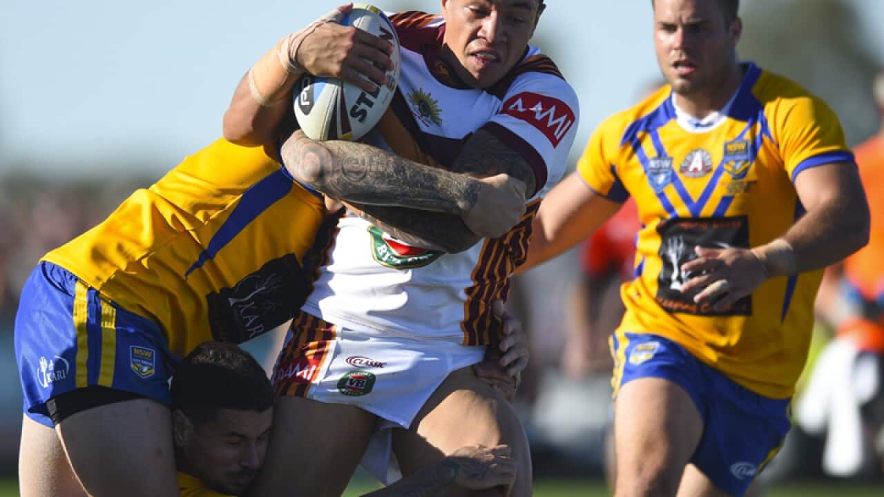 Tyson Frizell of Country (C) is tackled Blake Austin of City