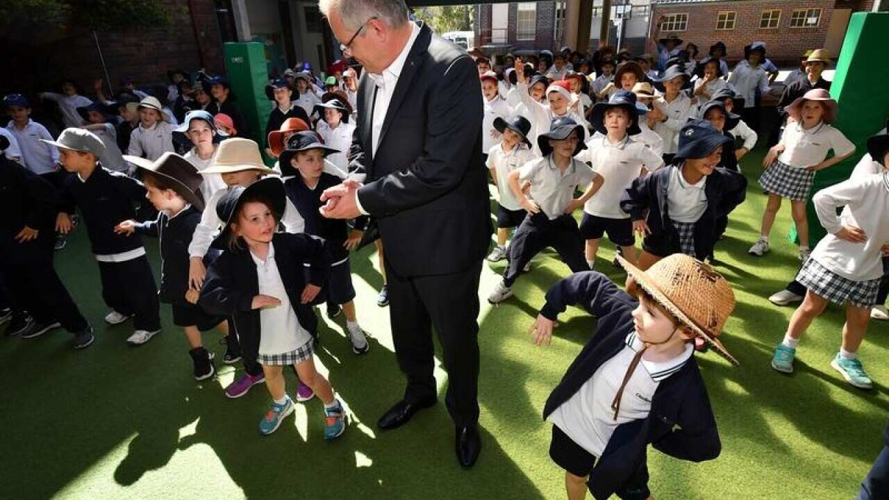 Prime Minister Scott Morrison dances with students