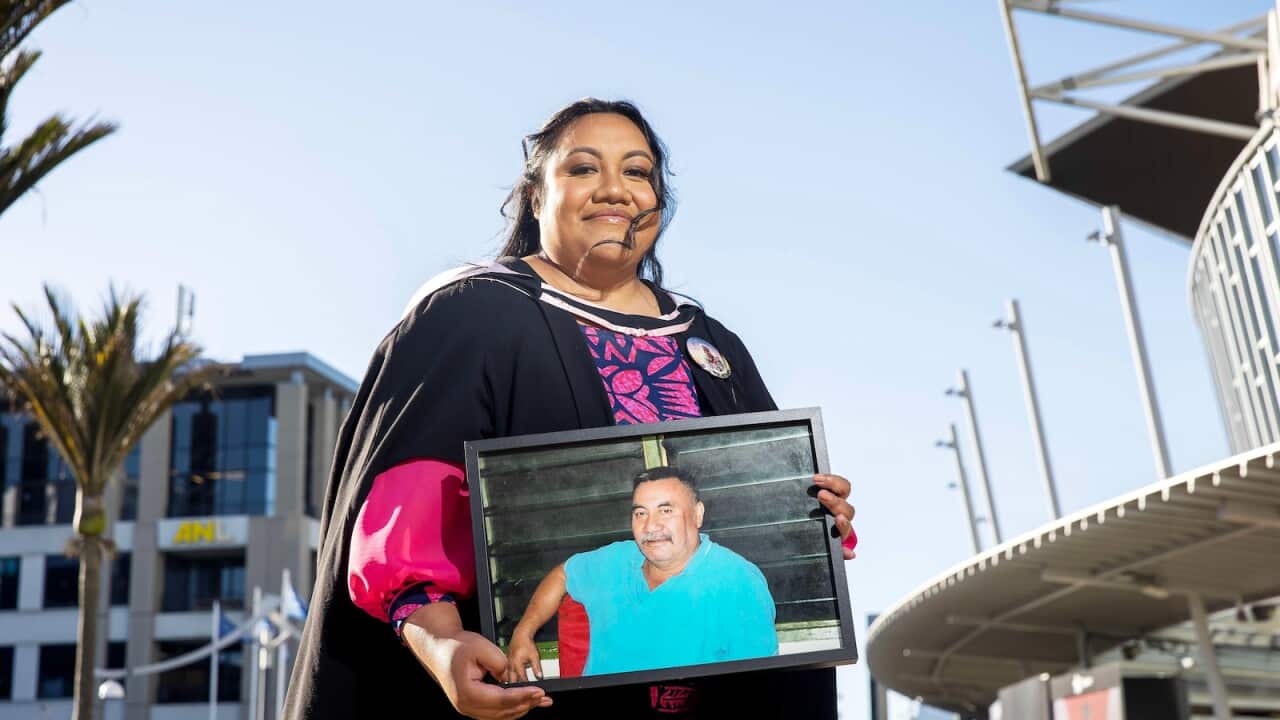 Graduate Sabrina Salome Wright with picture of late father.jpg