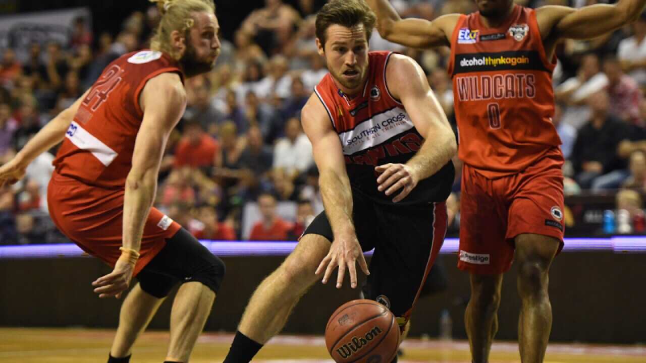 Mitch Norton of the Hawks and Jesse Wagstaff and Bryce Cotton