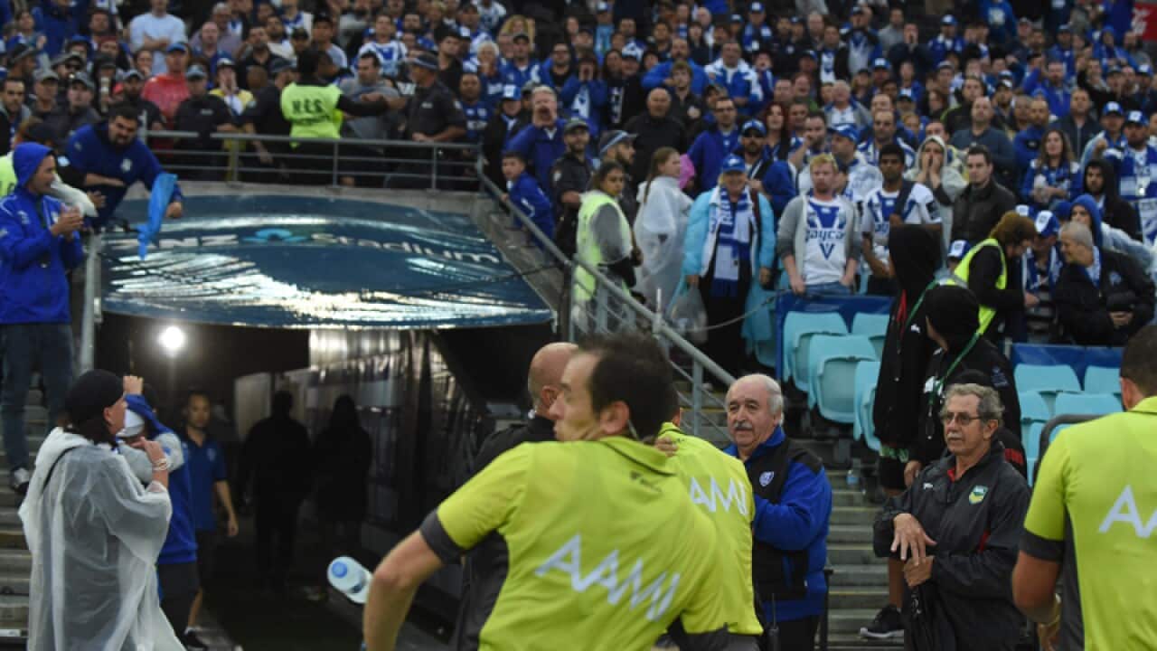 A touch judge is hit by a bottle at the end of a Round 5 NRL match