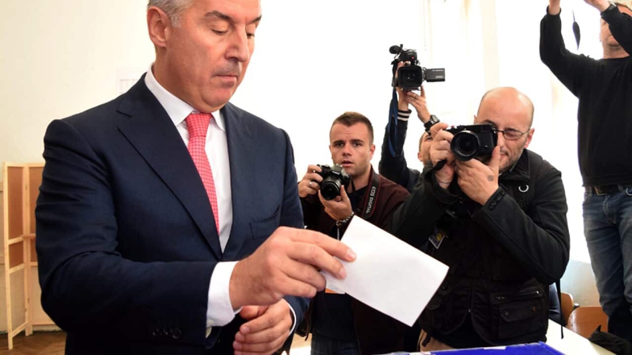 Montenegro's Prime Minister Milo Djukanovic casts his ballot