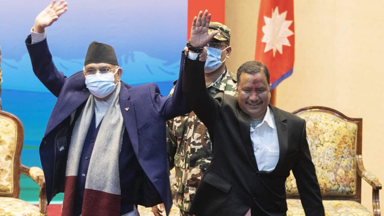 Nepal Prime Minister KP Oli, left, and leader of Nepal Communist Party group Netra Bikram Chand during a signing of peace agreement in Kathmandu, March 5, 2021.