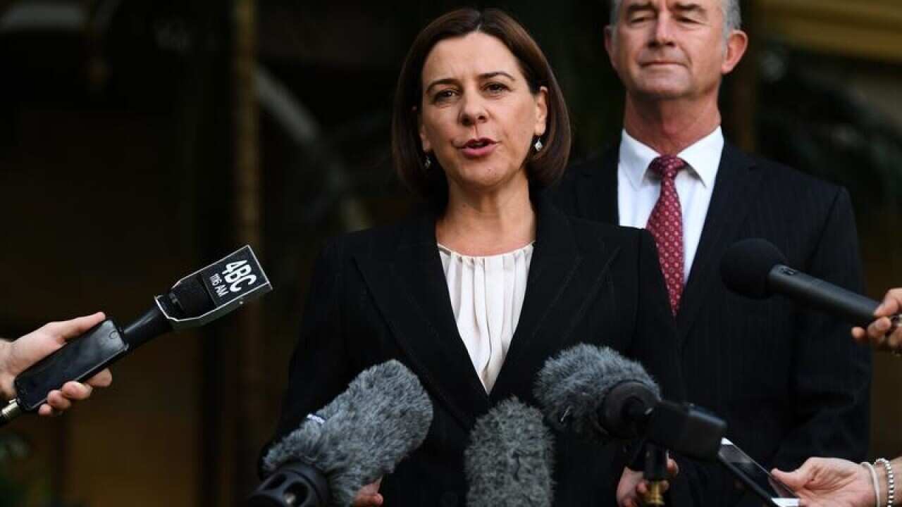 Deb Frecklington (L) at a media conference