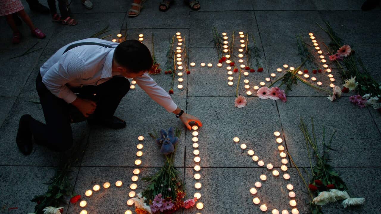 An Ukranian man lights up candles during a candle lit vigil for the victims of MH17 (Getty).