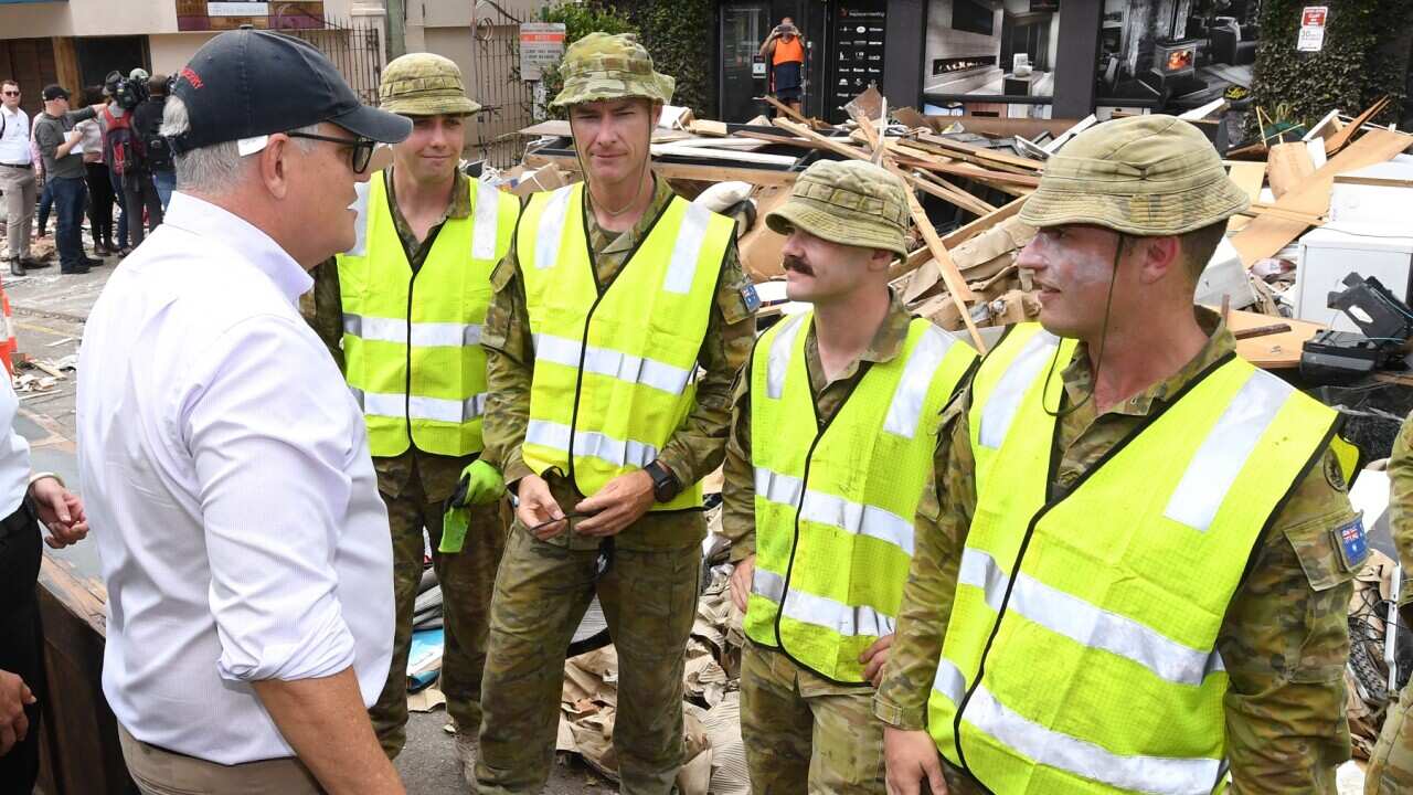 Prime Minister Scott Morrison talks to ADF members in the Brisbane suburb of Milton (AAP)