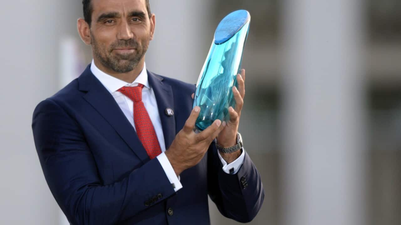 Adam Goodes holds up the Australian of the Year 2014 Award