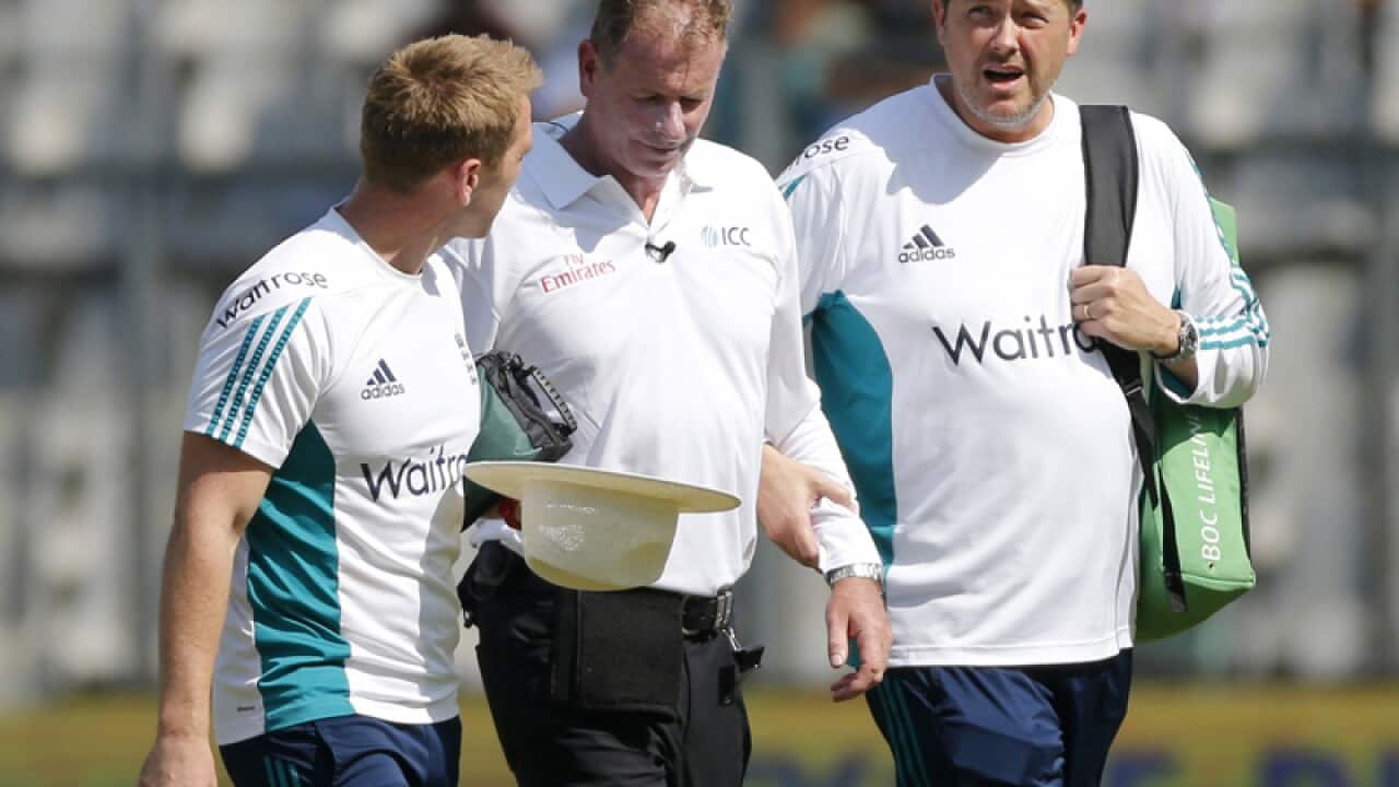 Umpire Paul Reiffel, center, leaves the field