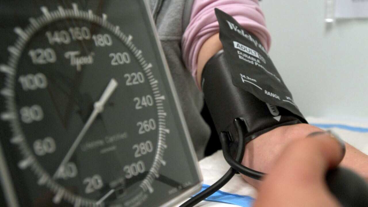 Blood pressure being taken by GP.
