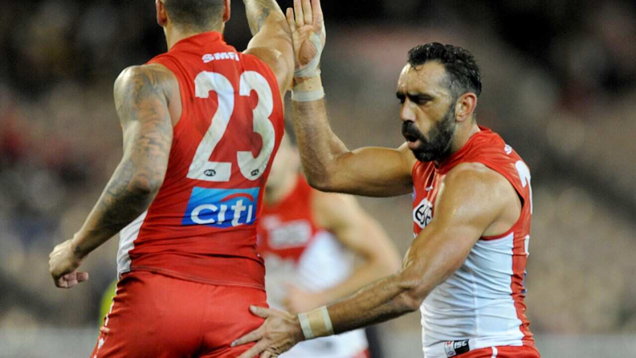Lance Franklin of Sydney is congratulated by Adam Goodes