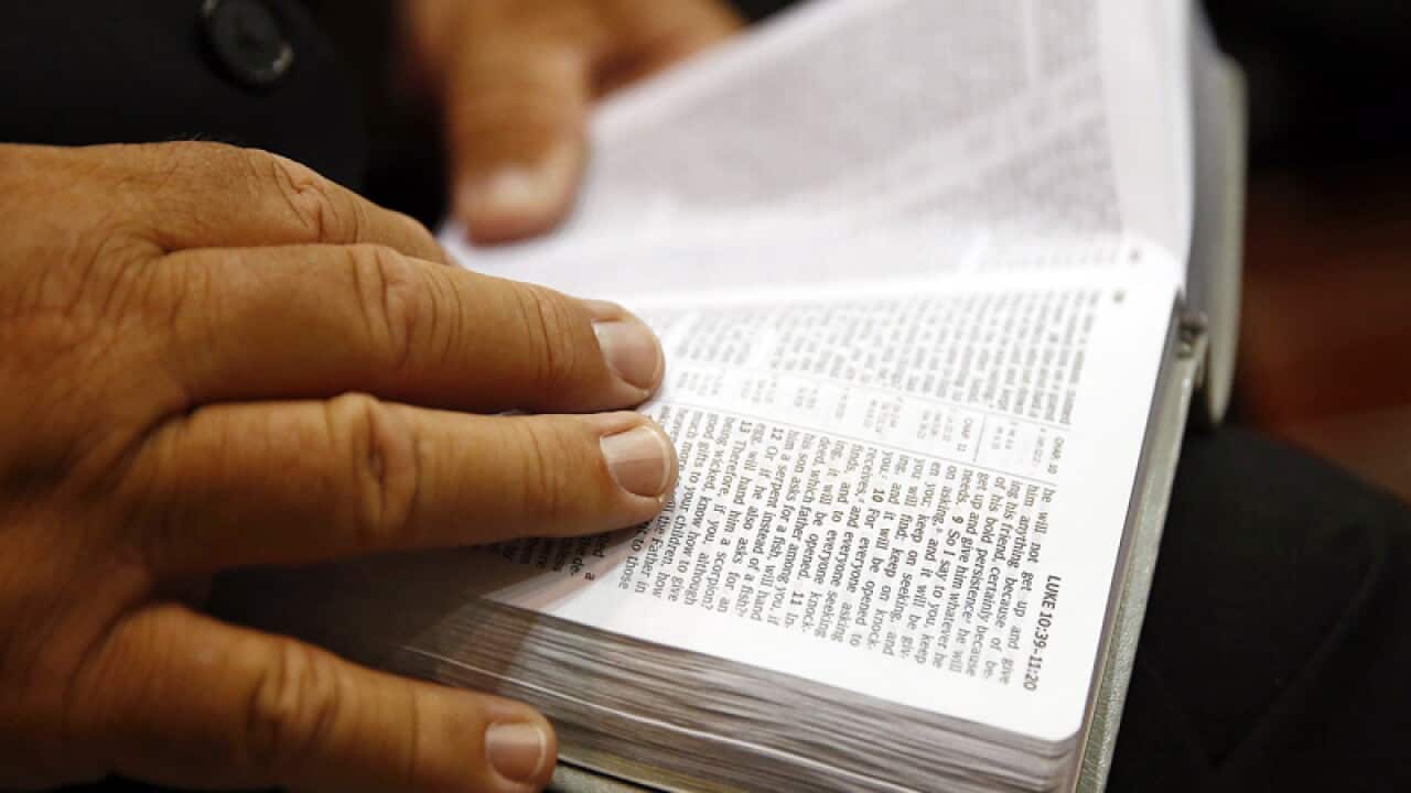 A congregation member reads a Bible