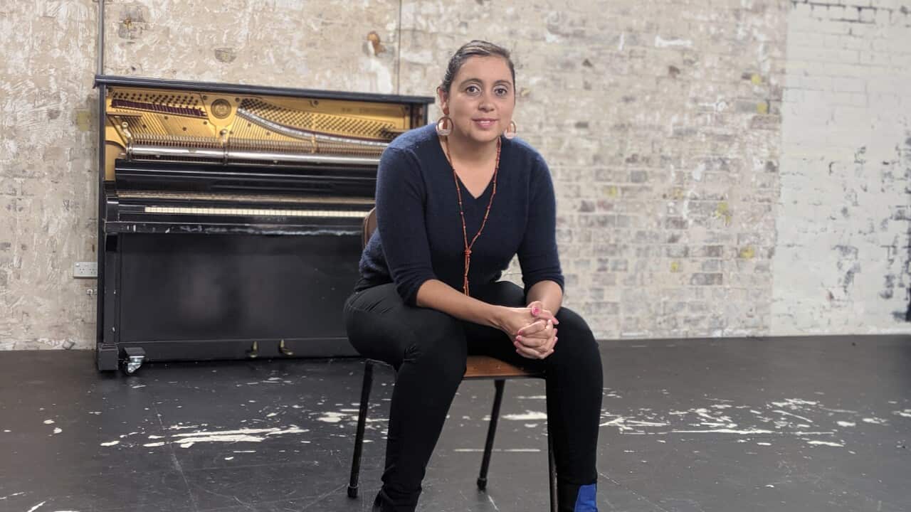 Kodie Bedford sitting on a chair in a large space