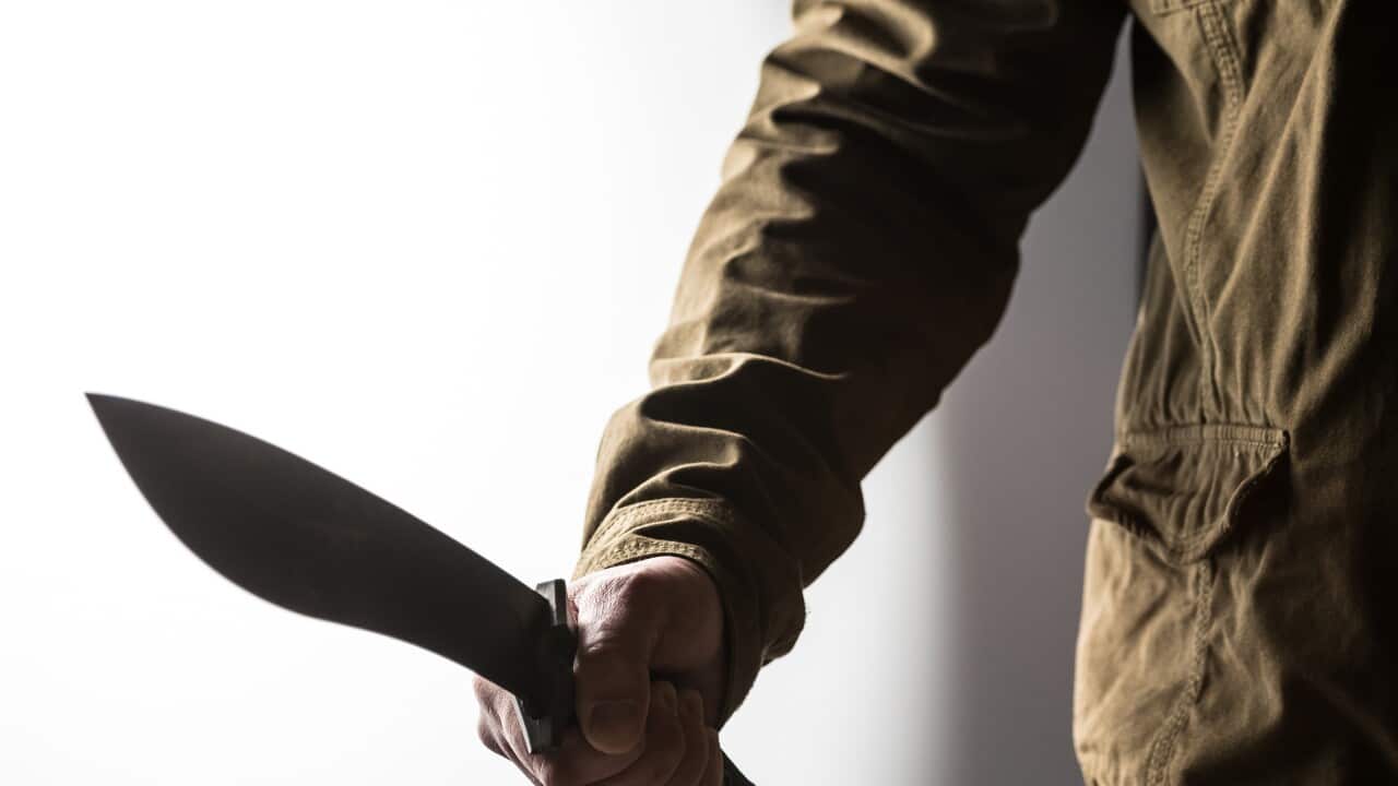 Man holding a machete in his hand