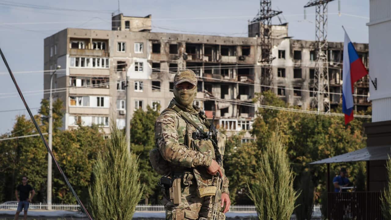 A picture taken during a visit to Mariupol organised by the Russian military shows Russian serviceman in Mariupol, Ukraine.