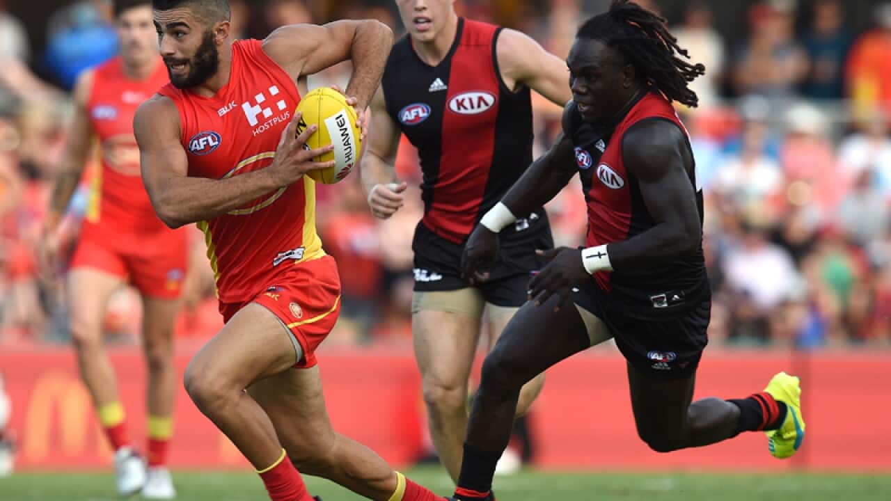 Suns player Adam Saad (left) with possession.