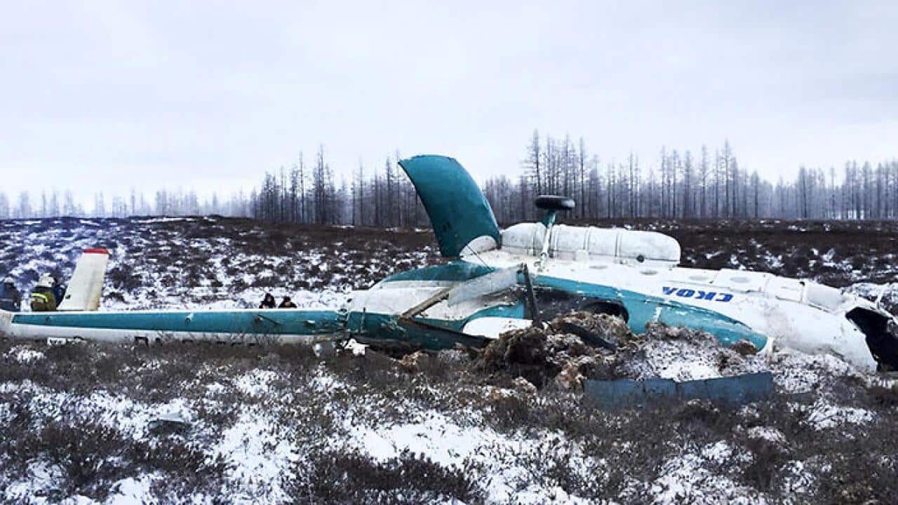 a Mi-8 helicopter lies on the ground after it crashed northeast of Staryi Urengoi in Hassana, Russia.