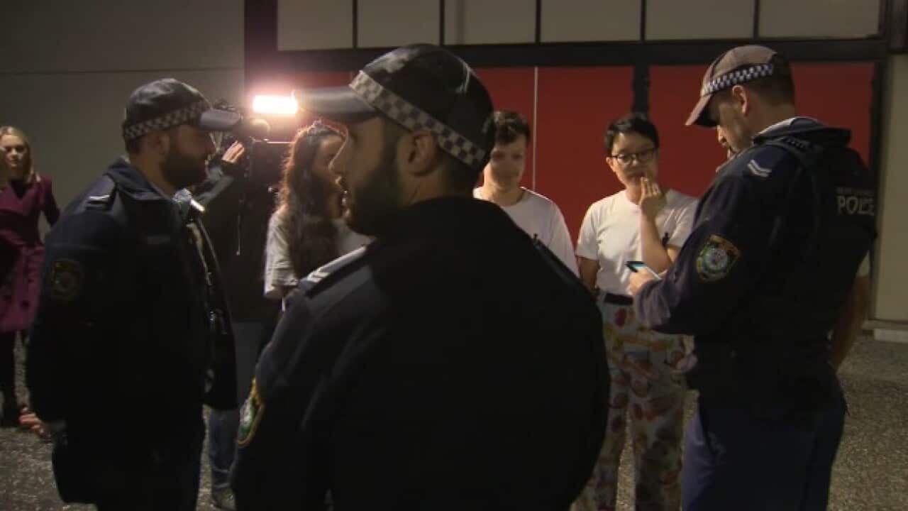 Police speak to activists. 