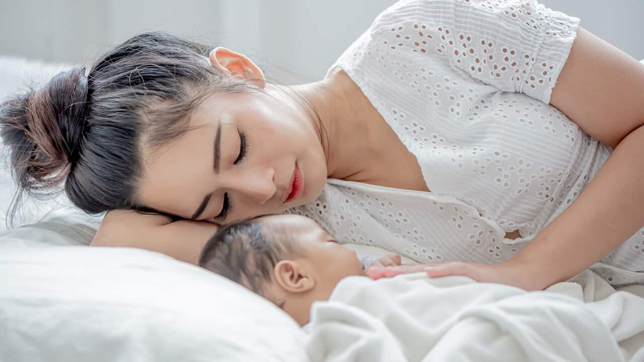 baby and asian mother sleeps