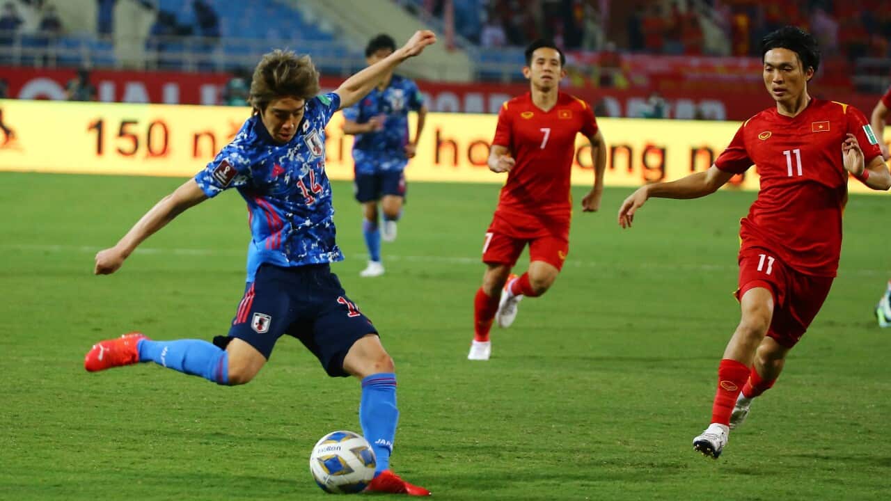 Junya Ito of Japan (L) in action during the the final round of the 2022 FIFA World Cup Asian Qualifiers match between Vietnam and Japan, at My Dinh stadium in Hanoi, Vietnam 11 November 2021.