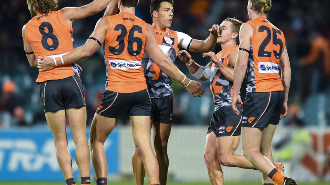 James Stewart of the Giants (centre) celebrates with team mates
