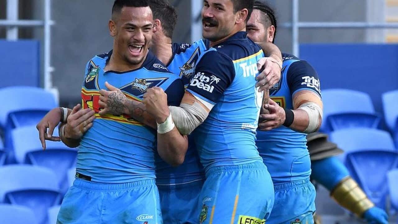 Phillip Sami of the Titans (left) celebrates scoring a try.