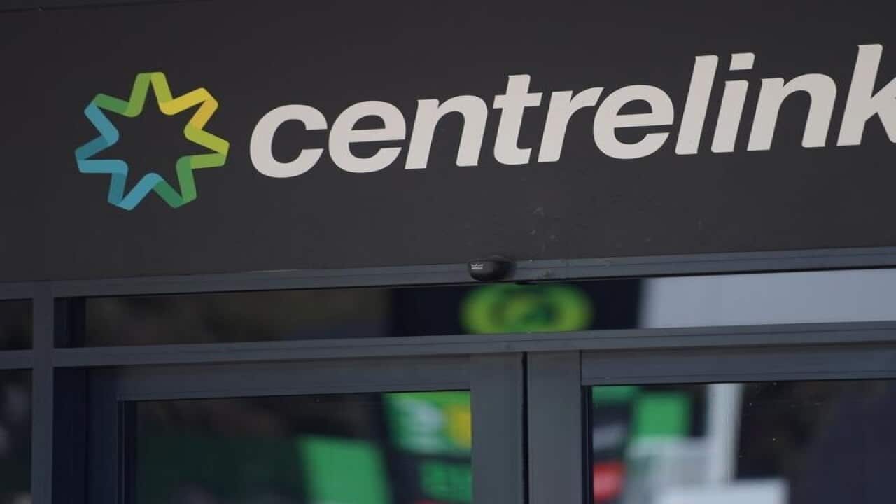 A Centrelink sign and logo above a door