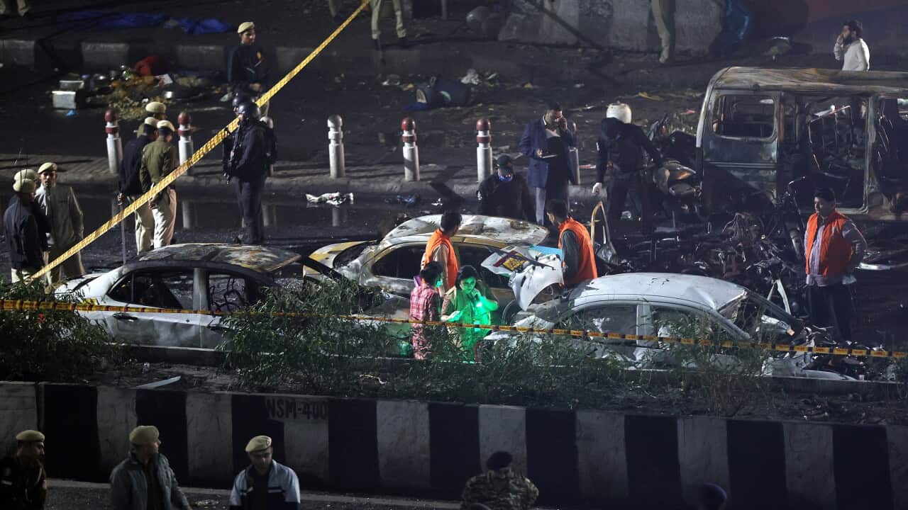 Indian police personnel inspect the scene of a blast near the red fort in New Delhi