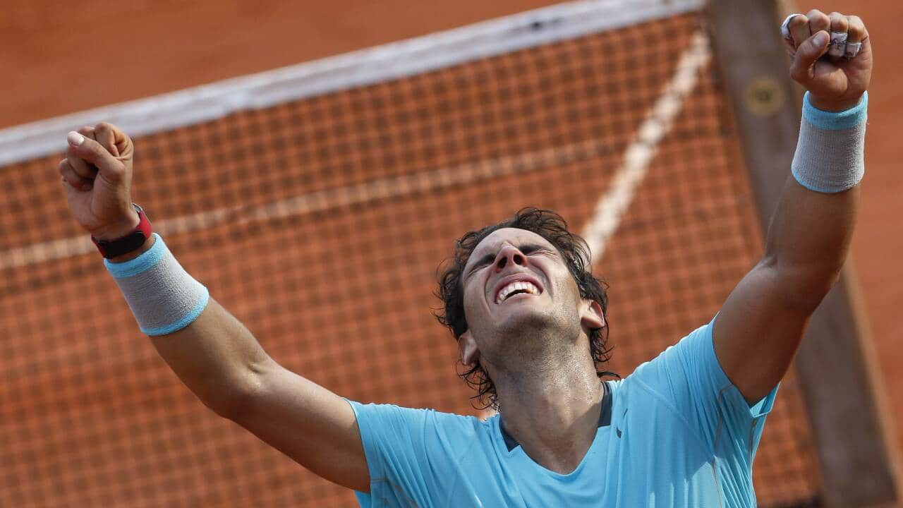 Spain's Rafael Nadal celebrates after winning the French tennis Open men's final match against Serbia's Novak Djokovic at the Roland Garros stadium in Paris on June 8, 2014. (AFP)