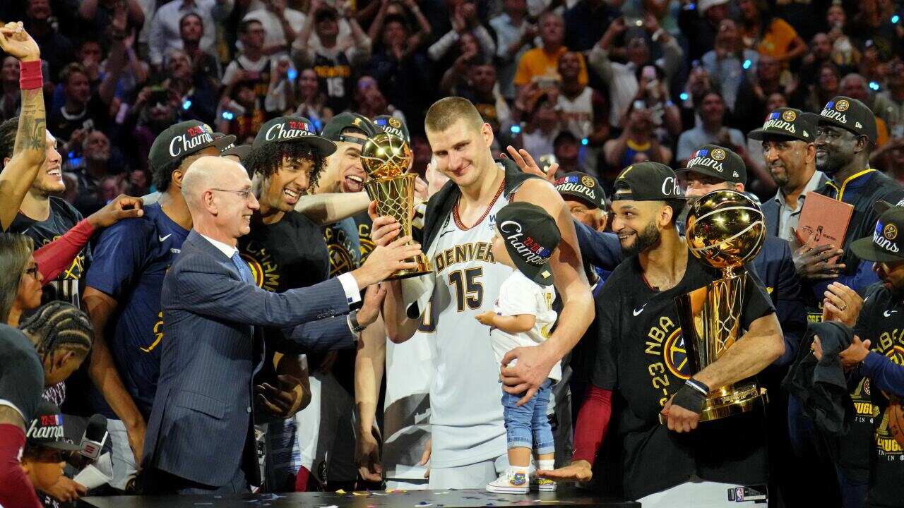 NBA commissioner Adam Silver presents Denver Nuggets center Nikola Jokic (15) the Bill Russell NBA Finals MVP Award after winning the 2023 NBA Finals against the Miami Heat at Ball Arena