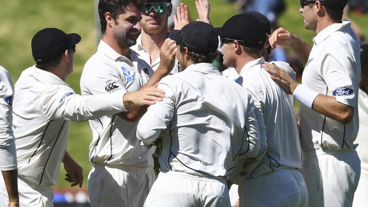 New Zealand's Colin de Grandhomme (2L) is congratulated