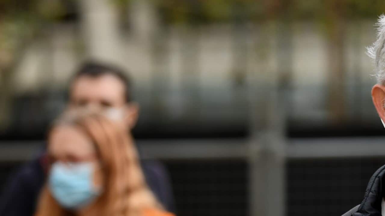 Protesters hold placards during a "Free The Refugees" rally at Sydney Town Hall in Sydney, Saturday, June 13, 2020. The Supreme Court on Thursday prohibited the protest from going ahead. (AAP Image/Bianca De Marchi) NO ARCHIVING