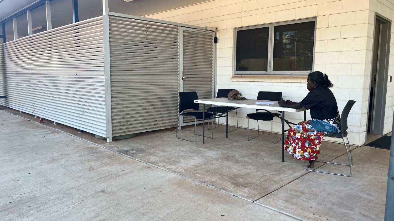An AIS interpreter on duty outside the Wadeye local circuit court..jpg