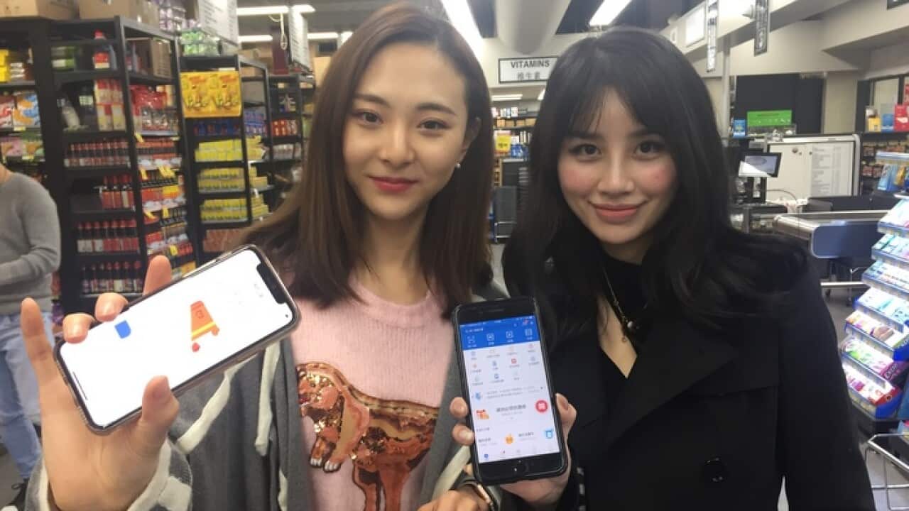 International students Vicky Yang and Hera Jang use Chinese mobile platforms to buy products in Sydney