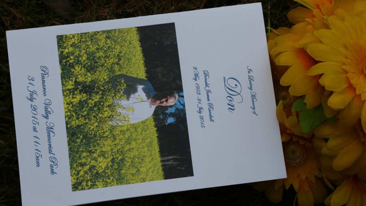 The order of service is seen at the funeral for Don Randall