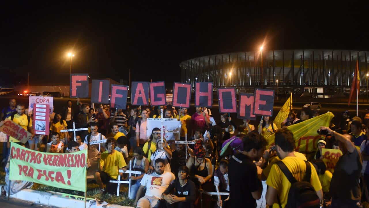 Demonstrators take part in a protest in front of the Nacional Mane Garrincha stadium in Brazil, calling for better public services ahead of the FIFA World Cup 2014. (AFP)