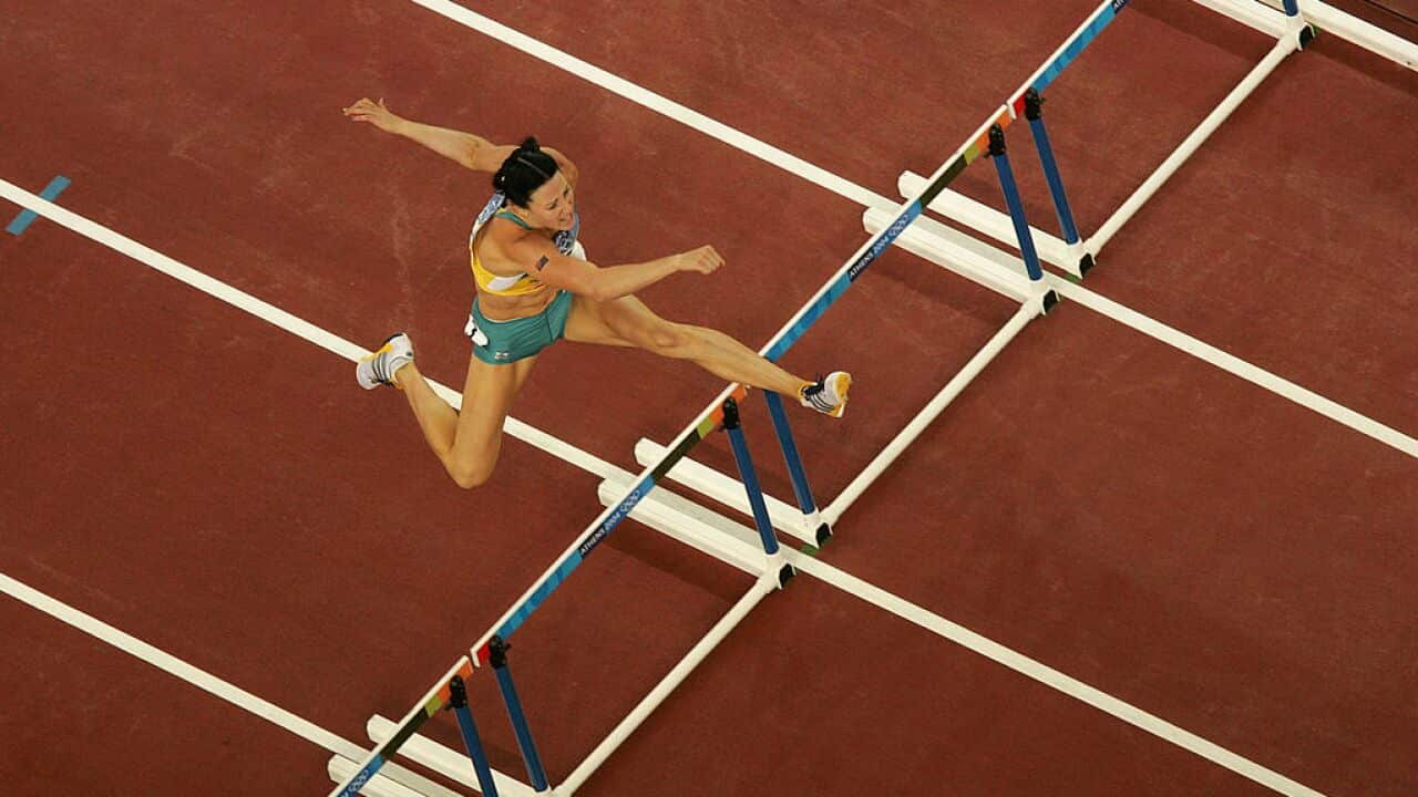 Jana Pittman competes in a 400m hurdles race.