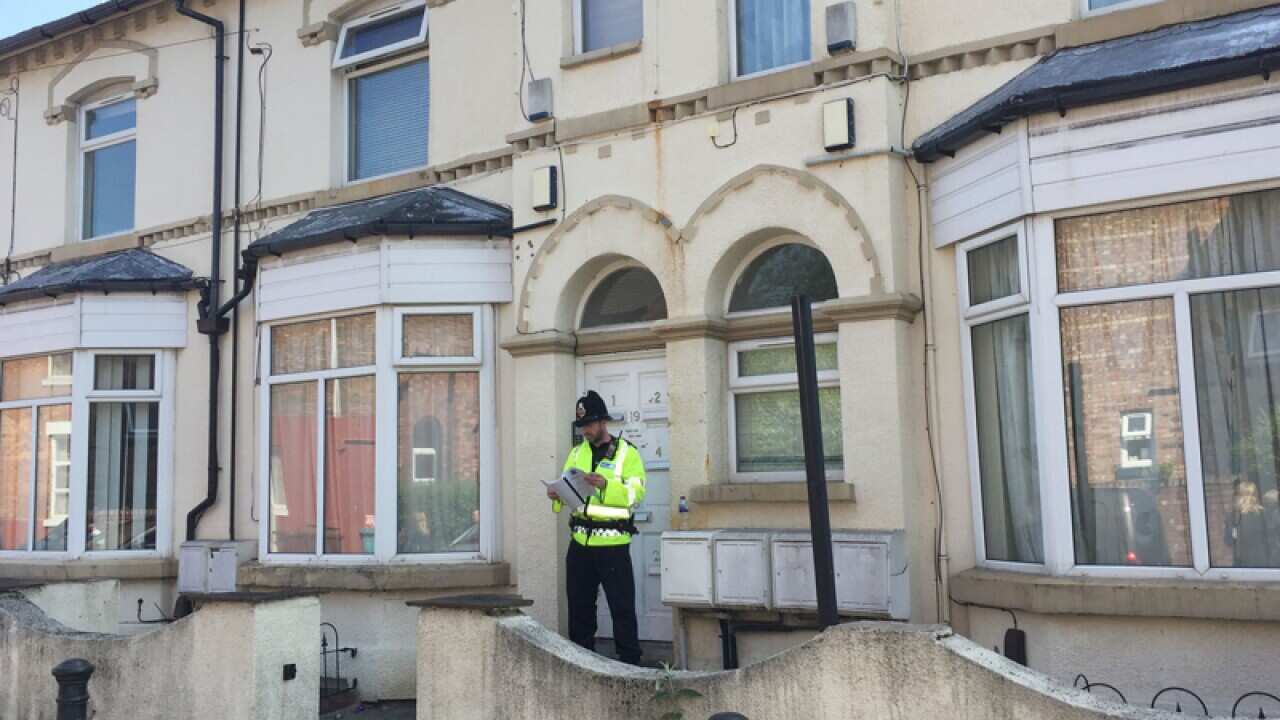 Police outside a property raided on Egerton Crescent, Manchester