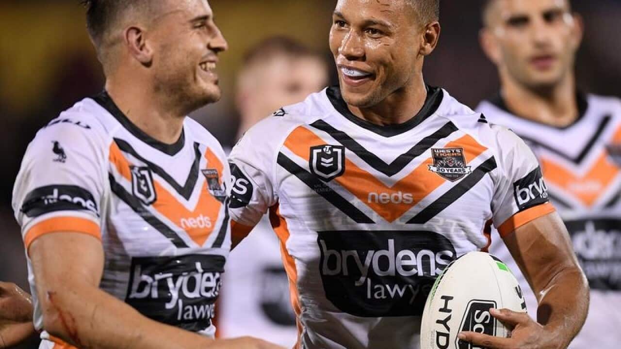 West Tigers star Moses Mbye (R)