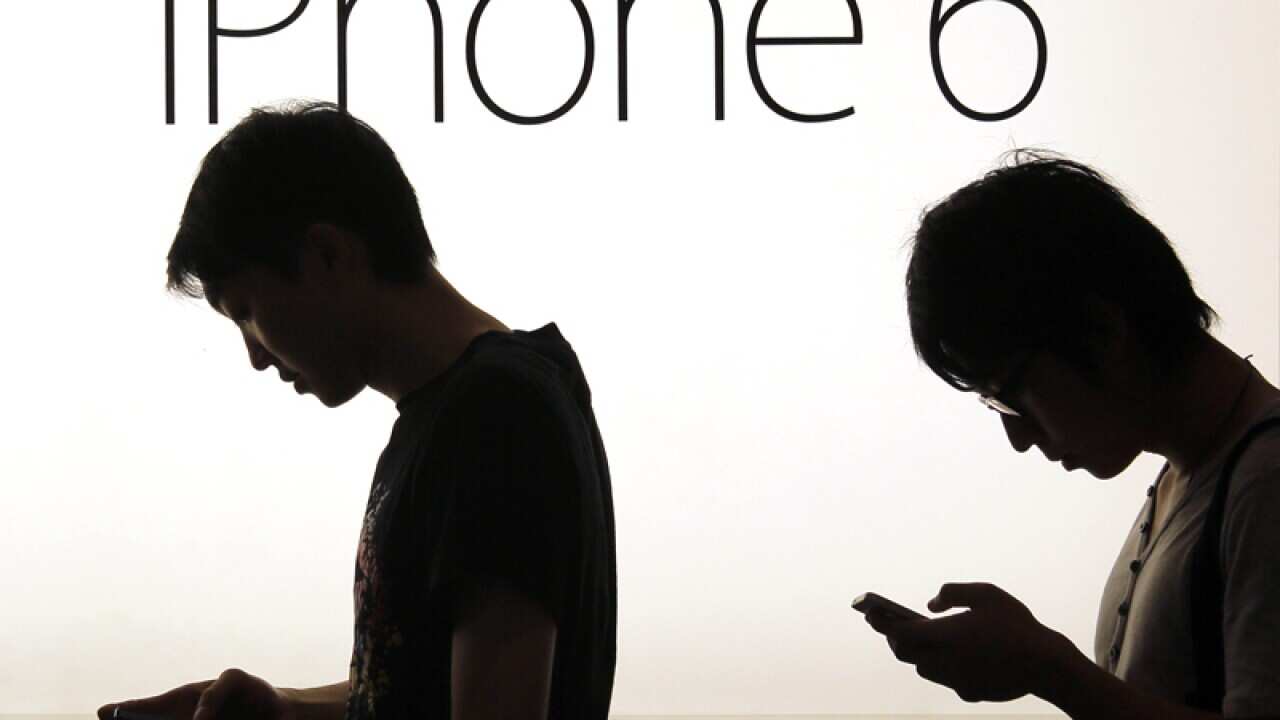 People wait to buy the new Apple iPhone in Hong Kong