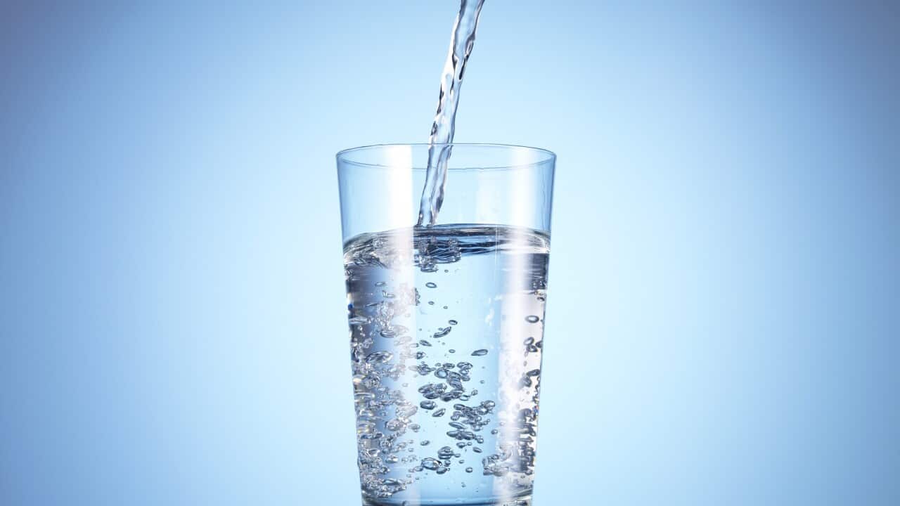 Cold drink water being poured into glass