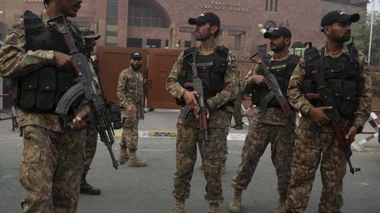 Pakistani troops stand guard at the main entrance of Gaddafi Stadium