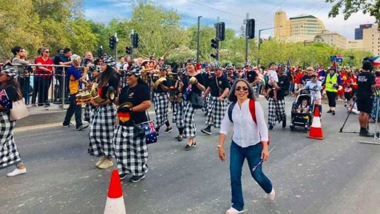 Coordinator Rita Soemarno (in white shirt) walks along with the Indonesian group in the 2019 Australia Day parade in Adelaide.