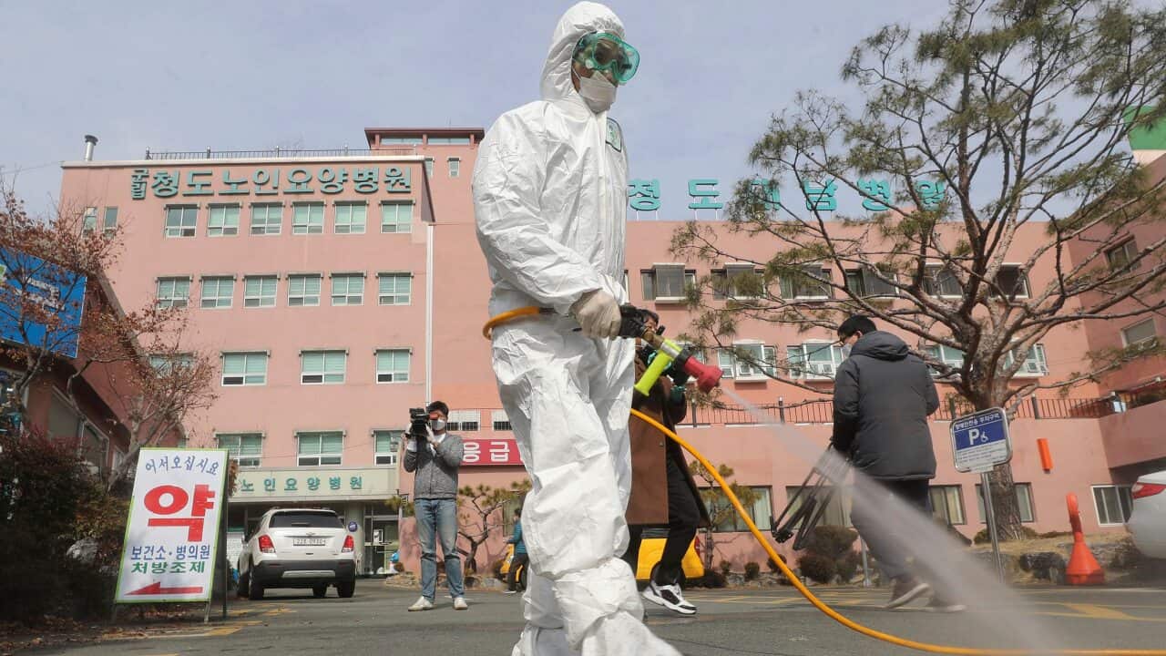 A worker wearing protective gears sprays disinfectant against the coronavirus in South Korea.