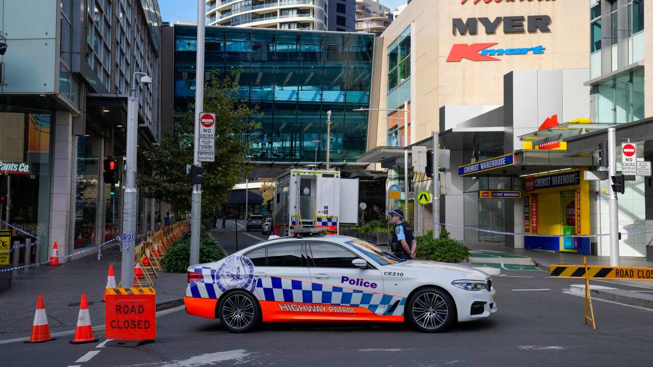 A police car parked across a road